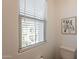 This well-lit toilet room features a modern toilet, window for natural light, and neutral wall decor at 4077 S Sabrina Dr # 25, Chandler, AZ 85248