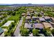 Stunning aerial view of neighborhood featuring manicured lawns, mature trees, and community park at 4167 E Sierra Madre Ave, Gilbert, AZ 85296