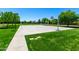 Community basketball court surrounded by lush green grass and trees, offering a space for sports and recreation at 4167 E Sierra Madre Ave, Gilbert, AZ 85296