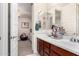 Bathroom featuring dual sinks, vanity storage, with doorway view to adjoining room at 4167 E Sierra Madre Ave, Gilbert, AZ 85296