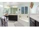Bright bathroom with a large soaking tub, dual vanities, and plenty of natural light at 4167 E Sierra Madre Ave, Gilbert, AZ 85296