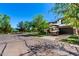 Charming two-story home with a well-maintained lawn, a paved driveway, and mature trees casting shadows on a sunny day at 4167 E Sierra Madre Ave, Gilbert, AZ 85296