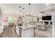 Open-concept kitchen with a granite island and stainless steel appliances flows into a cozy living space at 4167 E Sierra Madre Ave, Gilbert, AZ 85296