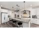 Bright kitchen featuring white cabinetry, granite countertops, pendant lighting, and stainless steel appliances at 4167 E Sierra Madre Ave, Gilbert, AZ 85296