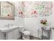 Charming powder room with floral wallpaper, white wainscoting, and a decorative mirror at 4167 E Sierra Madre Ave, Gilbert, AZ 85296