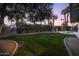 Expansive backyard with lush lawn, mature trees, and sparkling pool at 4228 N 87Th St, Scottsdale, AZ 85251