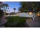 Expansive backyard boasts a lush lawn, refreshing pool, and swaying palm trees, ideal for outdoor enjoyment at 4228 N 87Th St, Scottsdale, AZ 85251