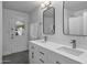 Bathroom features dual sinks, a large mirror, modern fixtures, and tiled floors at 4228 N 87Th St, Scottsdale, AZ 85251