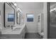 Bathroom features dual sinks, large mirrors, modern fixtures, and tiled floors at 4228 N 87Th St, Scottsdale, AZ 85251