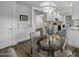 Dining area with a glass table, view of the kitchen, and wood-look flooring for a sleek modern design at 4228 N 87Th St, Scottsdale, AZ 85251
