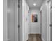 Hallway with wood floors, white walls, and built-in storage cabinets at 4228 N 87Th St, Scottsdale, AZ 85251