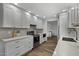 Bright kitchen boasts white cabinetry, stainless steel appliances, light countertops, and wood-look floors at 4228 N 87Th St, Scottsdale, AZ 85251