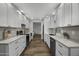 Modern kitchen featuring white cabinetry, stainless steel appliances, and hardwood flooring at 4228 N 87Th St, Scottsdale, AZ 85251