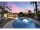 Sparkling pool surrounded by manicured landscaping and a stunning twilight sky at 4228 N 87Th St, Scottsdale, AZ 85251