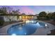 Relaxing pool area with lush landscaping, patio seating, and twilight sky at 4228 N 87Th St, Scottsdale, AZ 85251
