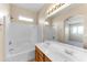 Well-lit bathroom showcasing double sinks, a shower/tub combo, and a vanity at 4234 S 62Nd Ln, Phoenix, AZ 85043