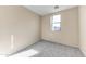 Bright bedroom featuring neutral walls, carpeted floor, and a window allowing natural light at 4234 S 62Nd Ln, Phoenix, AZ 85043