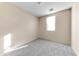 Empty carpeted bedroom with neutral walls and window with blinds at 4234 S 62Nd Ln, Phoenix, AZ 85043