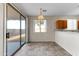 Dining area featuring vinyl floors, chandelier, and sliding glass door access to the backyard at 4234 S 62Nd Ln, Phoenix, AZ 85043
