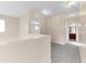 Upstairs hallway with neutral paint, white trim, and lighting fixtures at 4234 S 62Nd Ln, Phoenix, AZ 85043