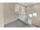 Well-lit hallway with carpeted floor, white railing, and multiple windows at 4234 S 62Nd Ln, Phoenix, AZ 85043
