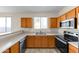 Bright kitchen with stainless steel appliances, wood cabinetry, and a window view at 4234 S 62Nd Ln, Phoenix, AZ 85043