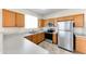 Well-lit kitchen features stainless steel appliances, wood cabinets, and light countertops at 4234 S 62Nd Ln, Phoenix, AZ 85043