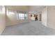 Spacious living room featuring neutral carpeting, an open floorplan, and lots of natural light at 4234 S 62Nd Ln, Phoenix, AZ 85043