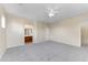 Large carpeted bedroom with ceiling fan and ensuite bathroom at 4234 S 62Nd Ln, Phoenix, AZ 85043