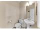 Cozy powder room featuring a pedestal sink and toilet with neutral paint at 4234 S 62Nd Ln, Phoenix, AZ 85043