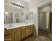 Bright bathroom featuring double sinks with a connecting shower/toilet space at 43271 W Mcclelland Dr, Maricopa, AZ 85138