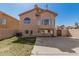 Exterior rear elevation featuring stucco exterior, privacy fence, patio, and lawn at 439 N Cobblestone St, Gilbert, AZ 85234