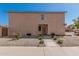 Backyard view features neutral stucco, desert landscaping, and a rear entrance at 439 N Cobblestone St, Gilbert, AZ 85234