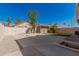 Backyard view of fenced yard with lawn and mature trees for shade at 439 N Cobblestone St, Gilbert, AZ 85234