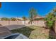 Fenced backyard with lawn and a tree offering shade at 439 N Cobblestone St, Gilbert, AZ 85234