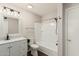 Bathroom featuring modern vanity, framed mirror, tub and shower combination with white cabinets at 439 N Cobblestone St, Gilbert, AZ 85234