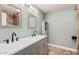 Bathroom featuring double vanity with undermount sinks and a decorative cabinet, plus tile flooring at 439 N Cobblestone St, Gilbert, AZ 85234