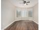 This bedroom includes luxury vinyl plank flooring, an ceiling fan and a bay window at 439 N Cobblestone St, Gilbert, AZ 85234