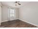 Light filled bedroom featuring beautiful flooring, ceiling fan, and window with sheer curtains at 439 N Cobblestone St, Gilbert, AZ 85234