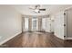 Bright main bedroom with ceiling fan, dark wood floors, and closet space at 439 N Cobblestone St, Gilbert, AZ 85234
