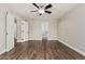 Bright bedroom featuring ceiling fan, and beautiful flooring with doorways and closet doors at 439 N Cobblestone St, Gilbert, AZ 85234