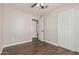Neutral bedroom features dark wood flooring, closet, and ceiling fan at 439 N Cobblestone St, Gilbert, AZ 85234