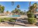 Sparkling community pool area with mature palm trees and plenty of space for sunbathing at 439 N Cobblestone St, Gilbert, AZ 85234