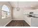 Dining area featuring modern chandelier and large arched window to let in natural light at 439 N Cobblestone St, Gilbert, AZ 85234