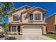 Charming two-story home with a tile roof, lush lawn, and an attached two-car garage at 439 N Cobblestone St, Gilbert, AZ 85234