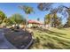 Well-maintained single-story home with a red tile roof and lush landscaping, creating curb appeal at 439 N Cobblestone St, Gilbert, AZ 85234