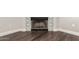 Close-up of the fireplace with decorative tile surround and dark wood flooring at 439 N Cobblestone St, Gilbert, AZ 85234