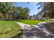 Well-maintained community green space with walking paths, mature trees, and landscaped areas at 439 N Cobblestone St, Gilbert, AZ 85234