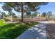 Manicured green space and walkways surrounding the property with mature trees and landscaping at 439 N Cobblestone St, Gilbert, AZ 85234
