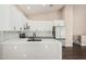 Open kitchen featuring white cabinets, quartz countertops, and modern appliances at 439 N Cobblestone St, Gilbert, AZ 85234